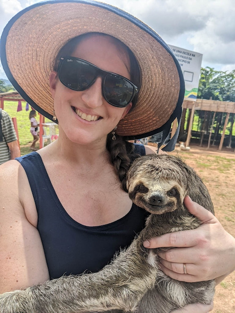 woman with sloth on amazon river